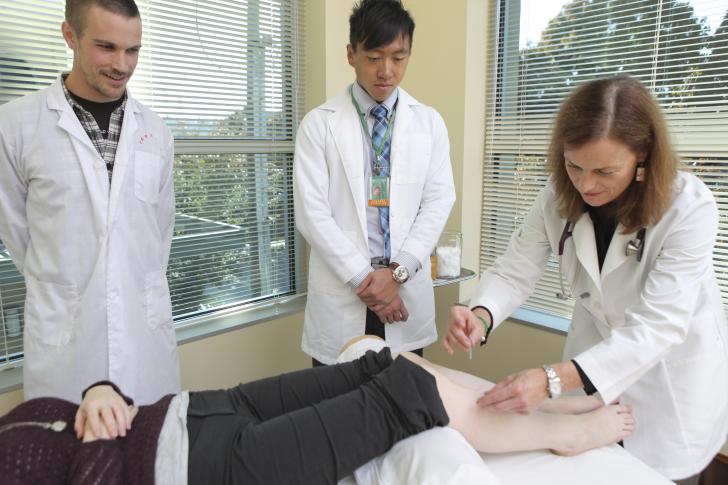 two students studying acupuncture 