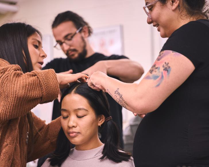 students practicing acupuncture