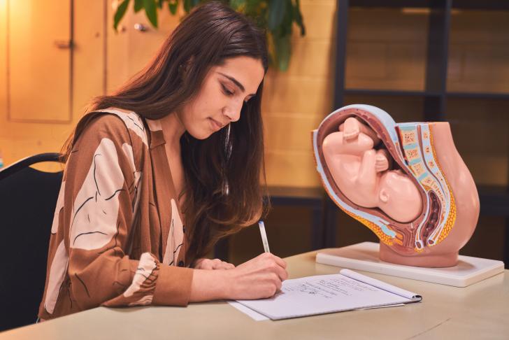 woman with a human anatomy model