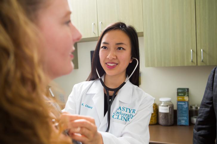 doctor using a stethoscope on a patient