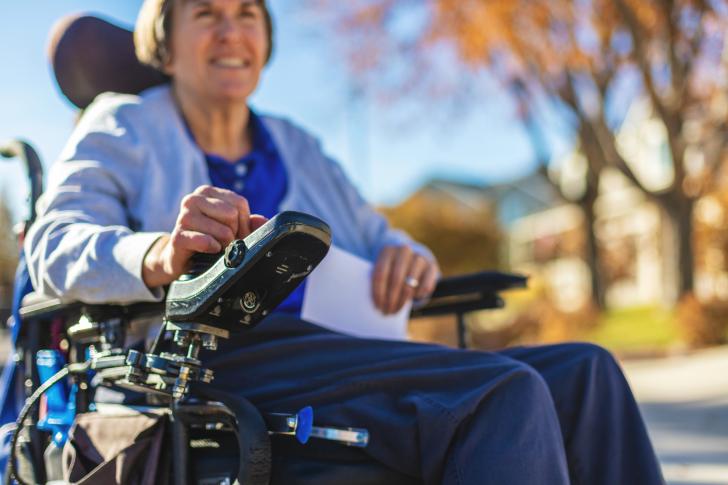 person in wheelchair smiling