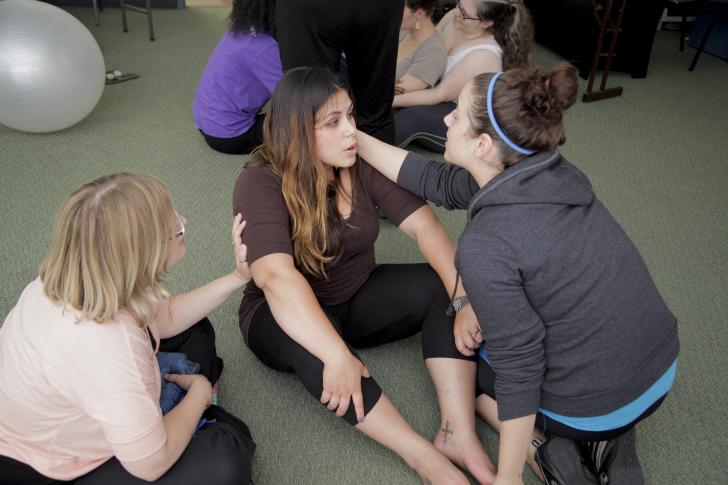 three women practicing breathwork