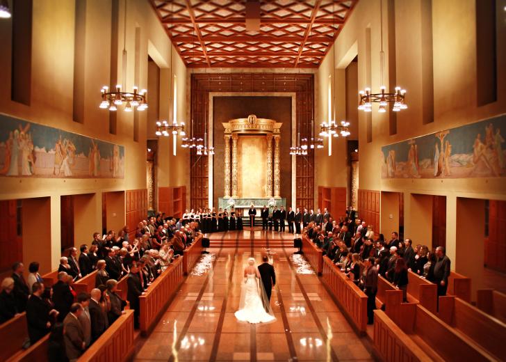 couple walking down aisle at Bastyr chapel