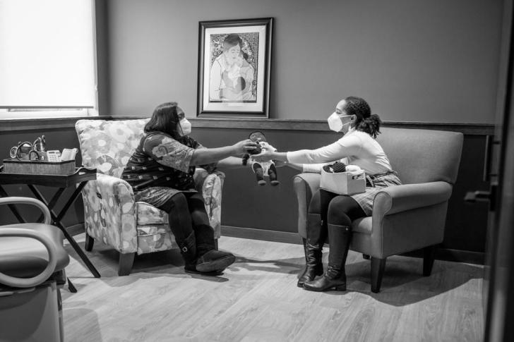 two women sitting across from each other