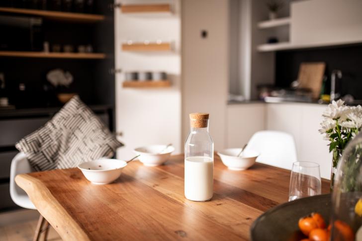 milk sitting on wooden table in kitchen