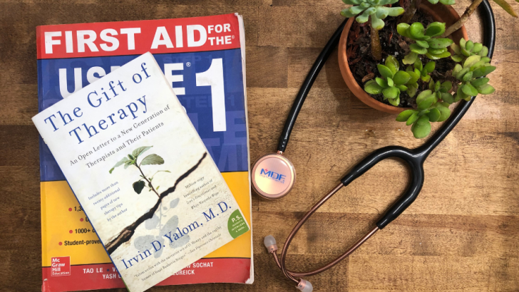 stack of two books on table and a stethescope