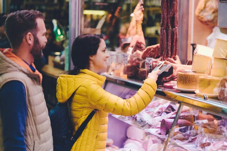person buying meat from local butcher