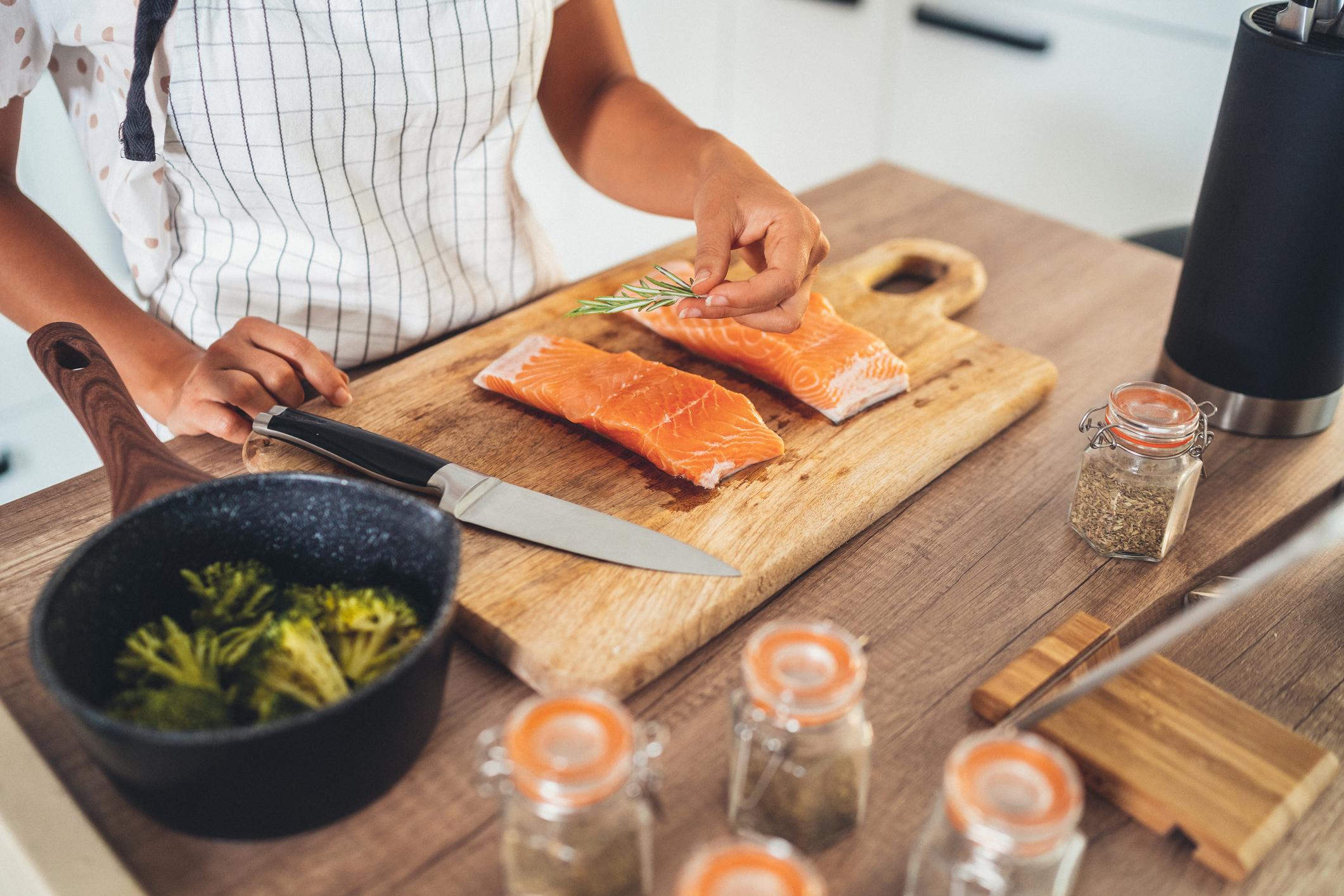 person preparing salmon