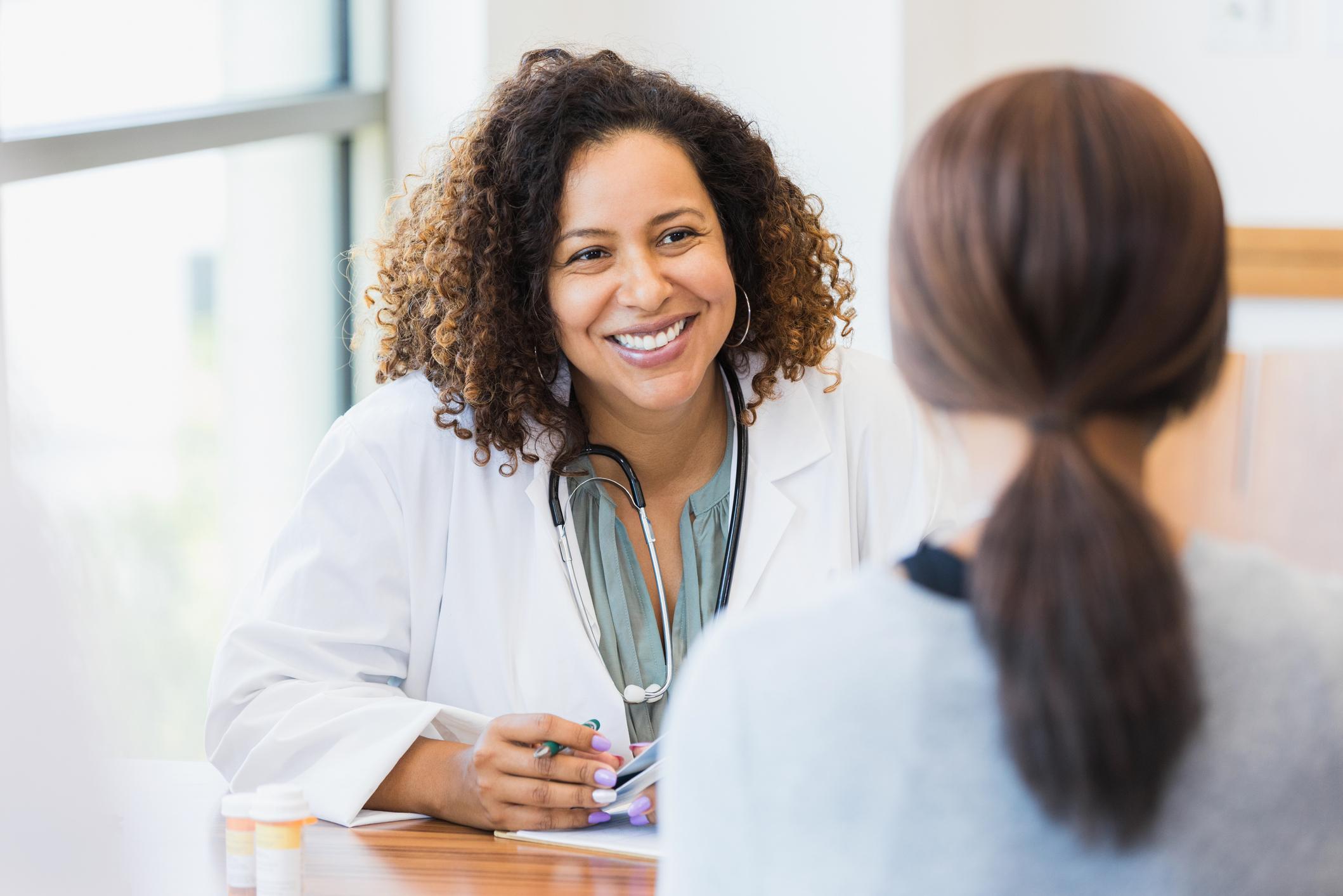 doctor speaking to patient smiling