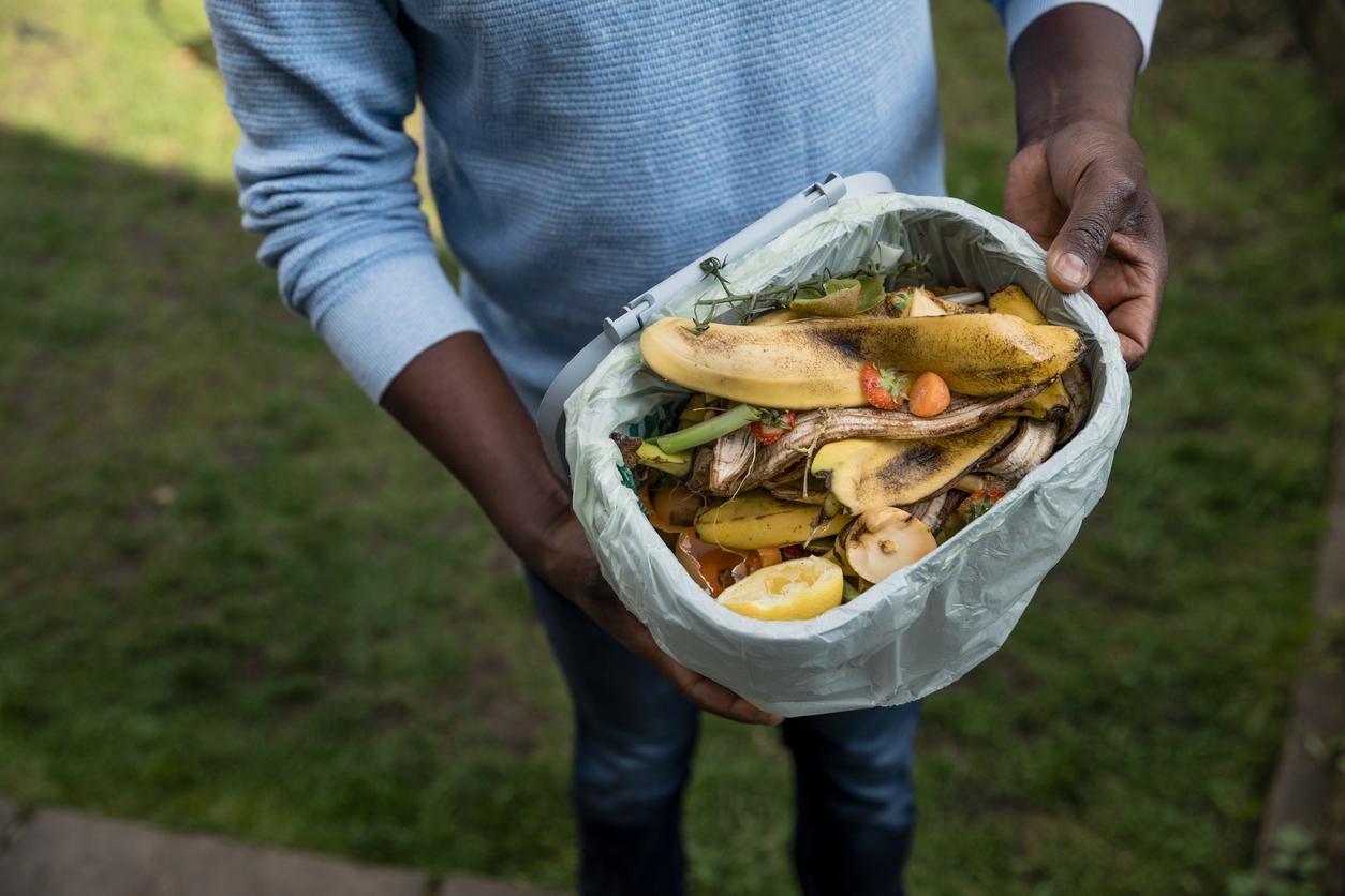 man holding compost bin