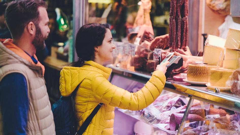 person buying meat from local butcher