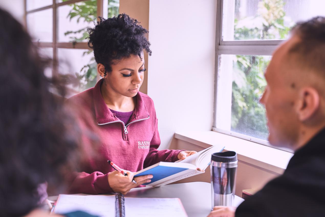 student looking at book