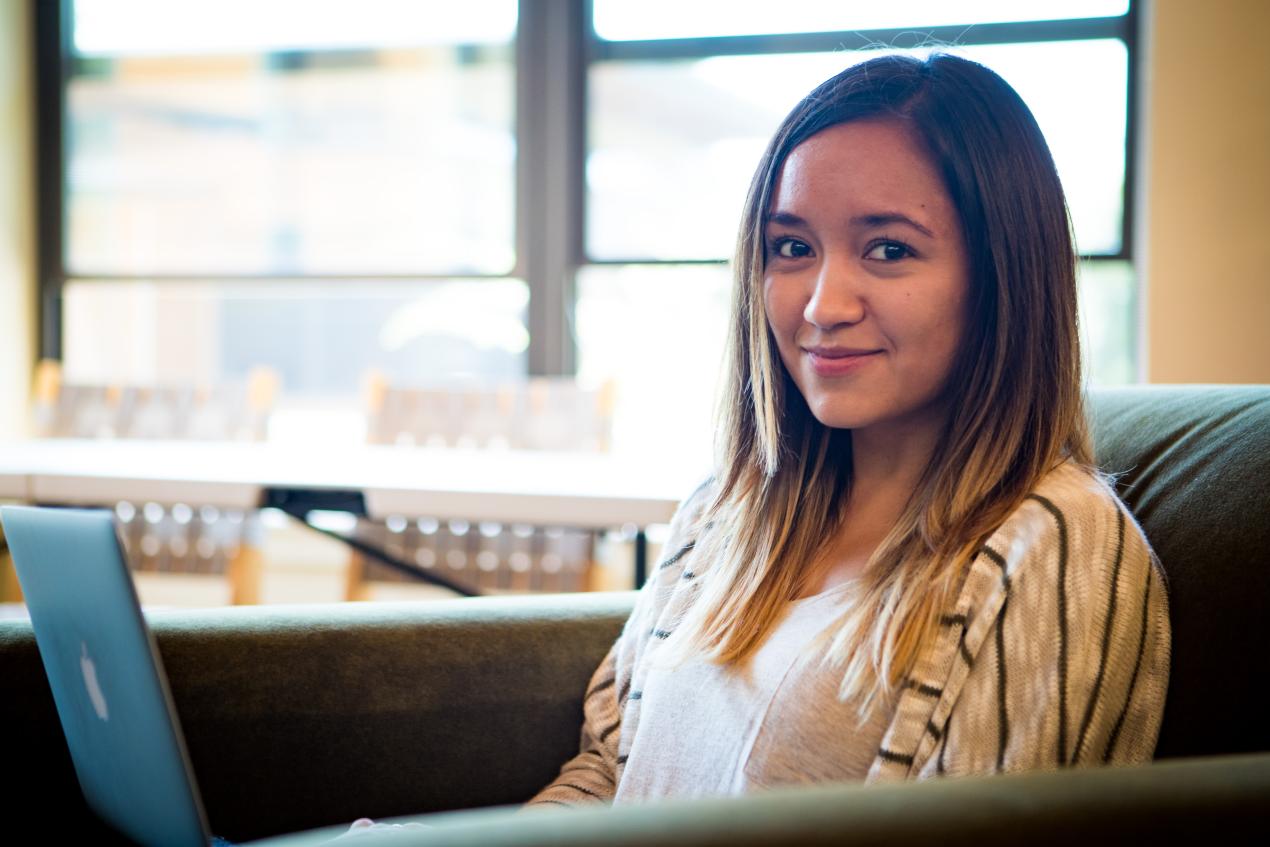 student sitting in chair looking at camera